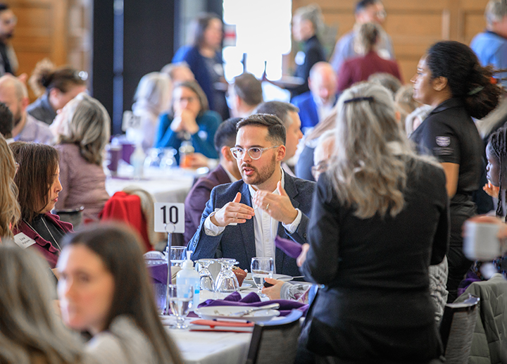 Staff sitting at a table for an event